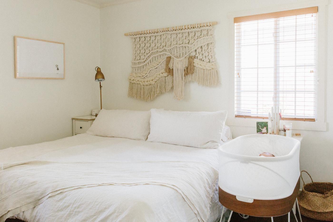 A bright, peaceful adult bedroom with a SNOO Smart sleeper