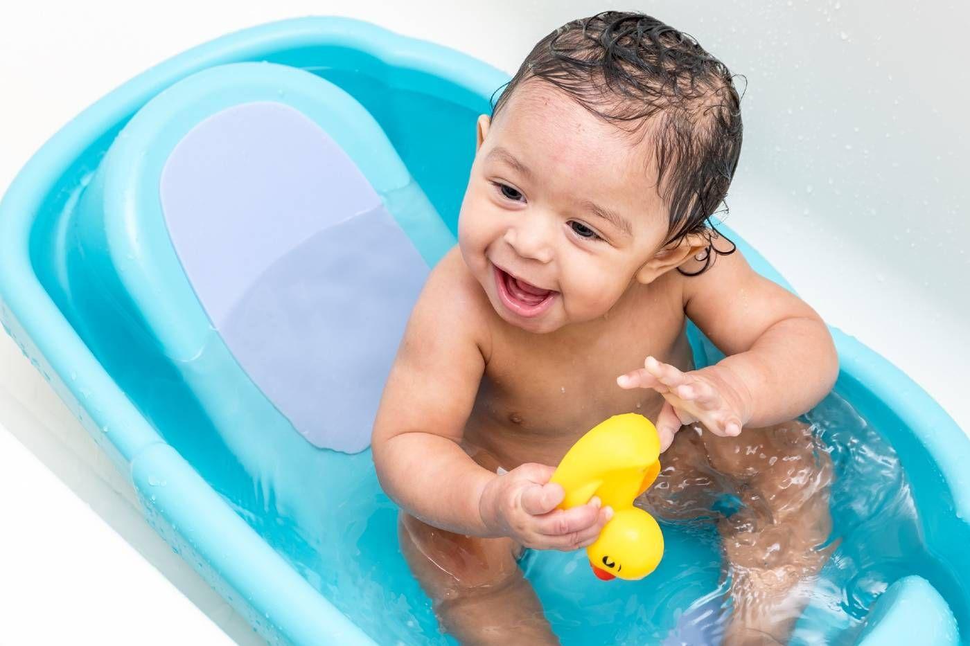 Baby bathing in a baby bathtub.