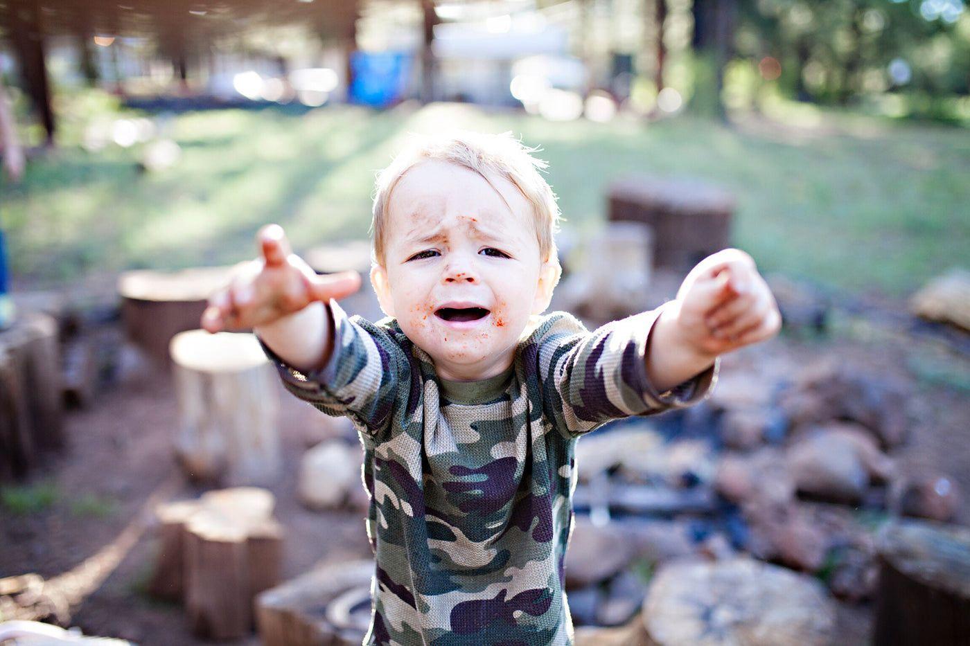 toddler with raised hands