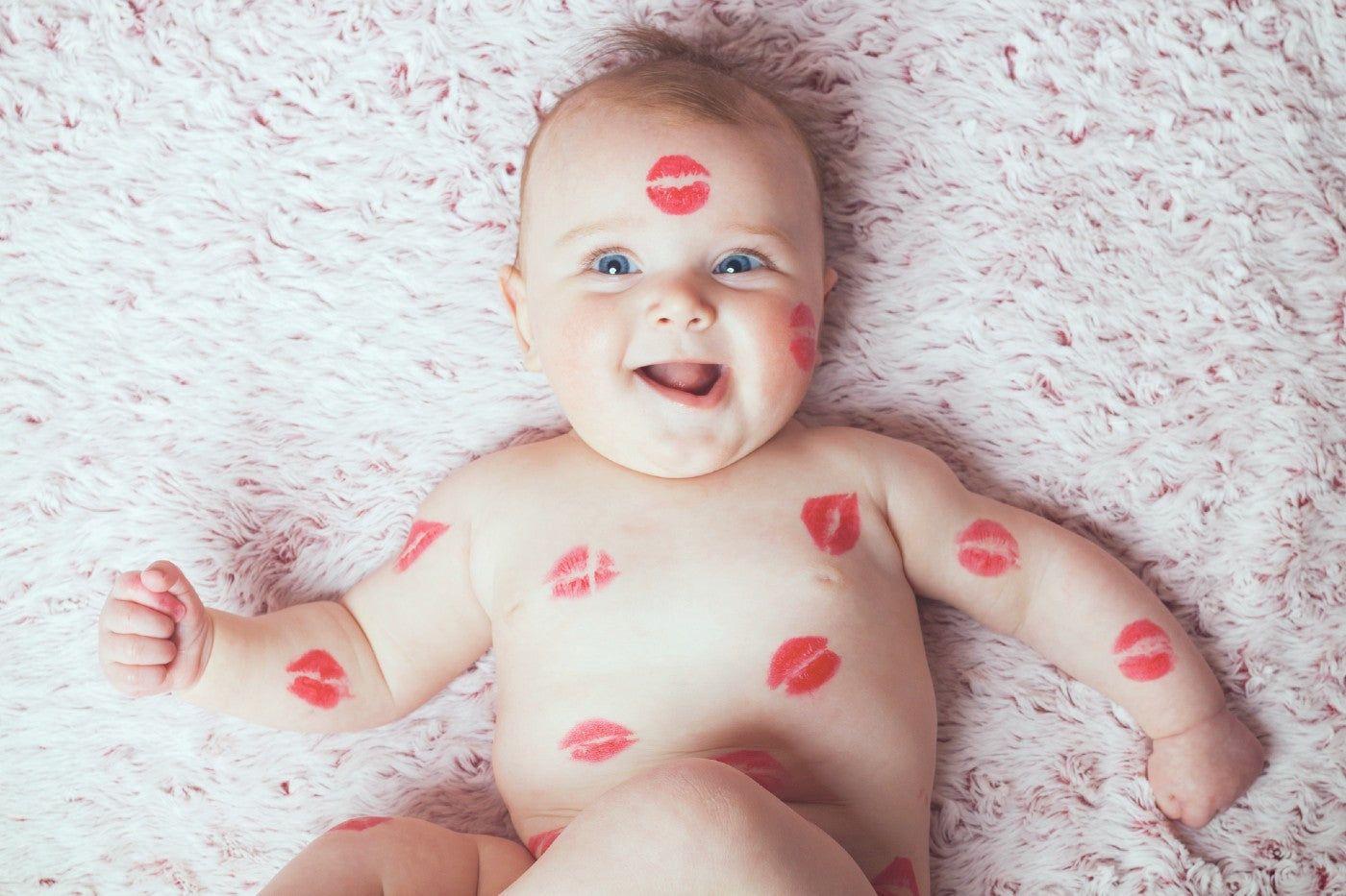 A cute baby covered in kiss marks