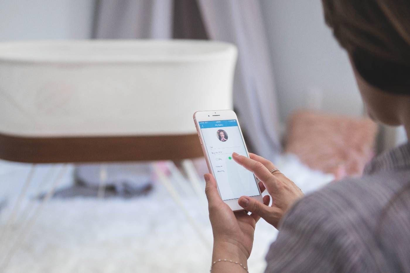 A mom uses the Happiest Baby App to customize her SNOO experience