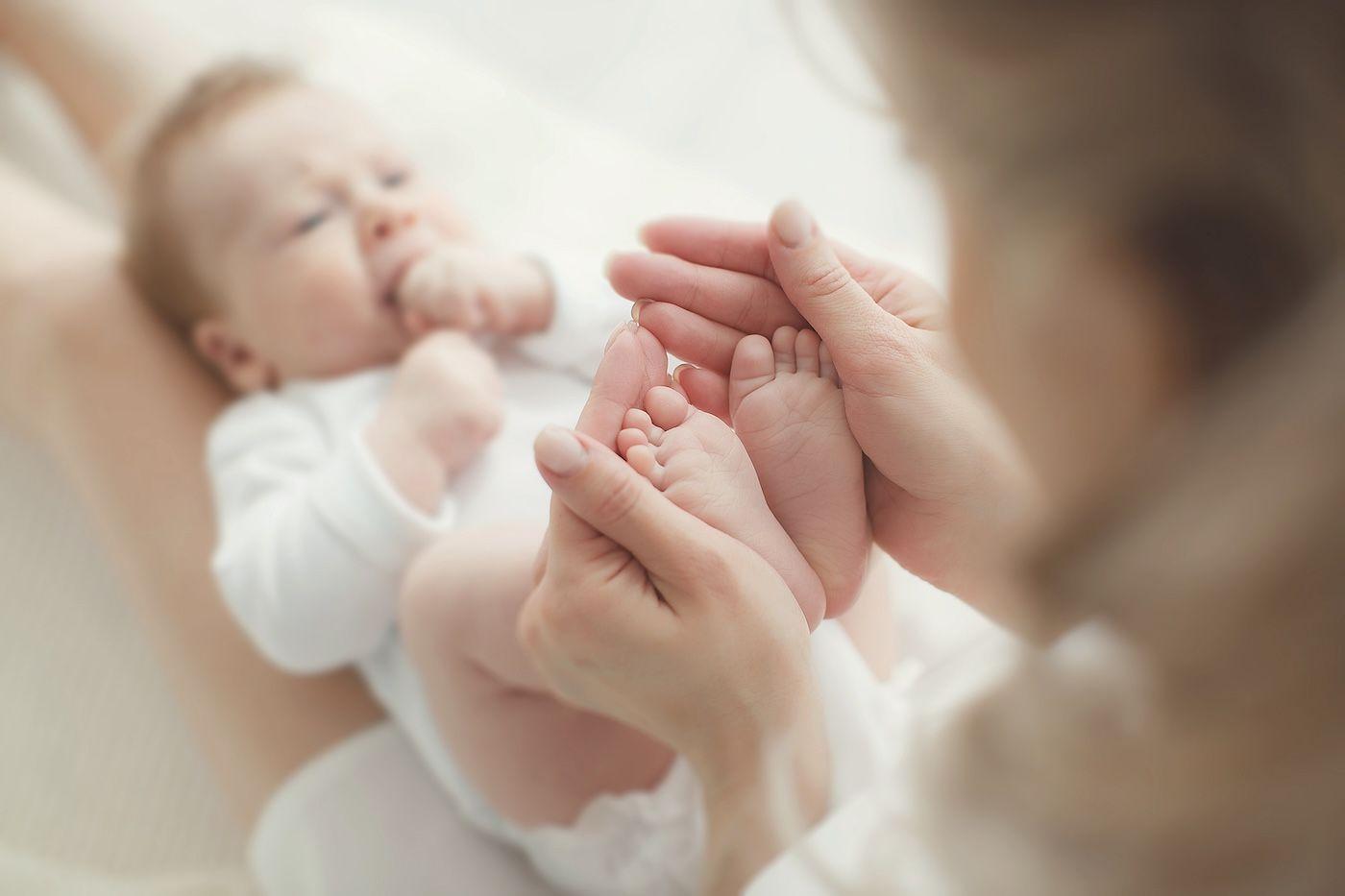 A mother plays with her baby