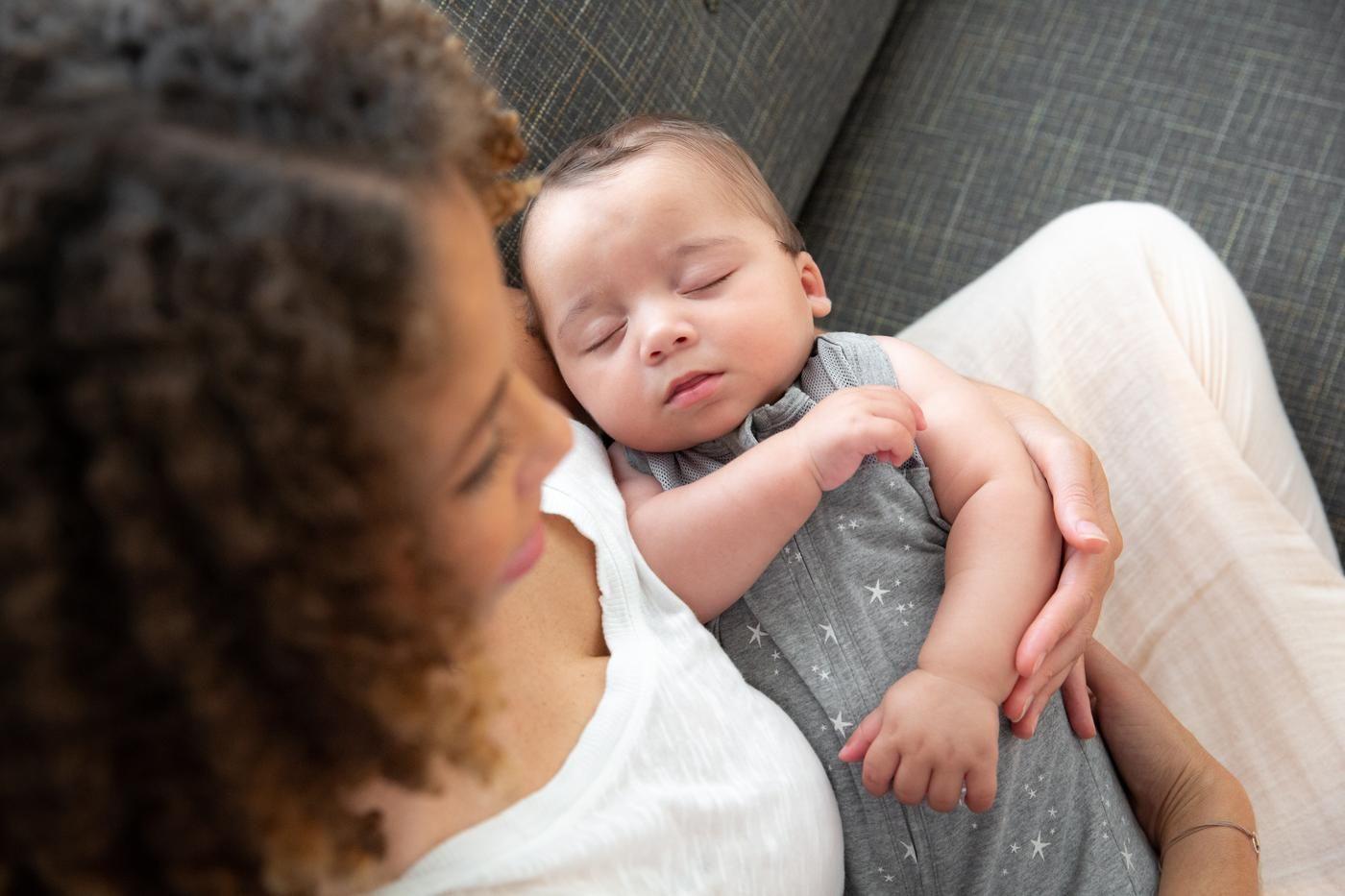 Baby sleeping in mother's arms